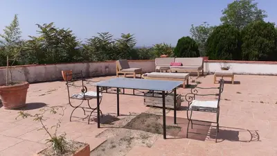 a patio with a table and chairs on a patio at Les chambres de Guillaunas Haut in Saint-Germain-des-Prés