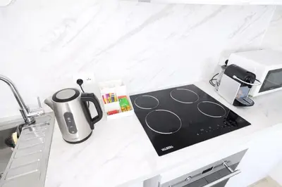 a kitchen counter with a sink and a coffee maker at T2 lumineux avec parking privé in Narbonne