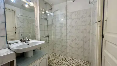 a white bathroom with a sink and a shower at Pavillon avec grande terrasse à l'abri des regard, piscine, clim - GN020-008 in Gruissan