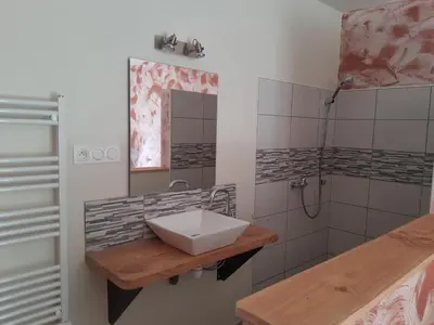 a bathroom with a sink and a shower at Le Rucher d'Ange in Quillan