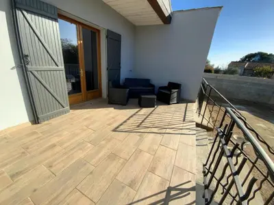 a balcony with a wooden floor and a door at La ceriseraie in Trausse