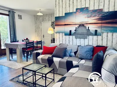 a living room with a couch and a table at La ceriseraie in Trausse