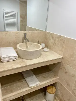a bathroom with a sink and a mirror at Entre Pins et Romarins in Bizanet