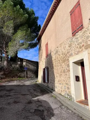 a brick building with a door on the side of it at Le Nid de l'Abbaye - Maison de charme rénovée in Saint-Hilaire