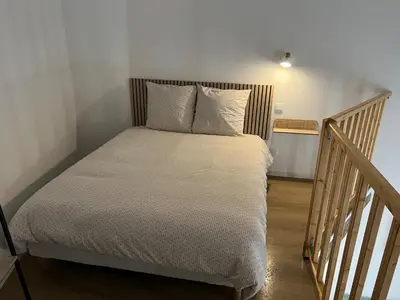 a bed with white sheets and pillows in a room at L'Appart cosy 52m2 avec local à vélo près du Canal du Midi in Capestang