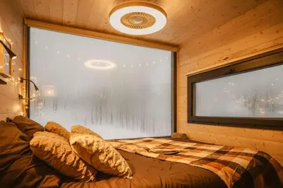 a bedroom with a bed and a large window at Homnest - Brumes des Hauts Bains - Coeur Pyrennees in Escouloubre