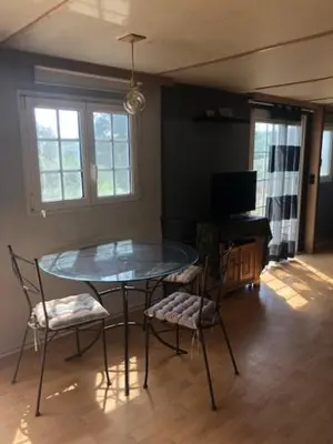 a dining room with a glass table and two chairs at appartement, deux chambres in Damiatte