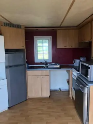 a kitchen with a sink and a stove top oven at appartement, deux chambres in Damiatte