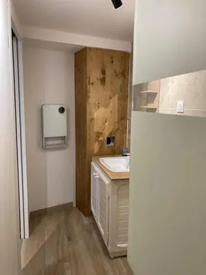 a small bathroom with a sink and a counter at Charmant studio avec vue sur le château de Montségur in Montferrier