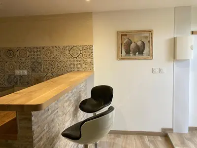 a bar with a table and a chair in a room at Charmant studio avec vue sur le château de Montségur in Montferrier