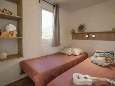 a room with two beds and a window at Camping 3 étoiles - Piscine - ccbefgh in Tuchan