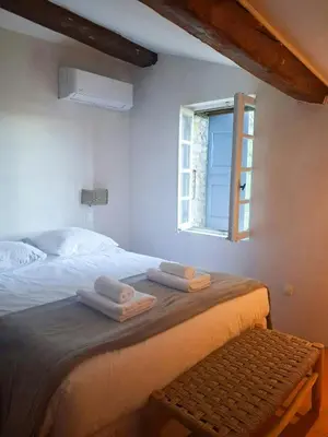 a bedroom with a bed with two towels on it at Mediterranean Haven In Pine Forest At Leucate in Roquefort-des-Corbières
