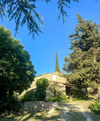an old church with a steeple in the background at Mediterranean Haven In Pine Forest At Leucate in Roquefort-des-Corbières