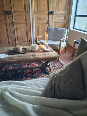 a living room with a couch and a table with candles at Mediterranean Haven In Pine Forest At Leucate in Roquefort-des-Corbières