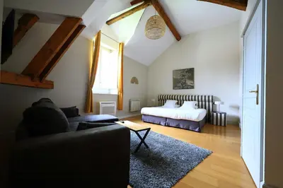 a living room with a bed and a couch at Old Hotel Reborn As An Elegant Getaway With Pool in Garrevaques