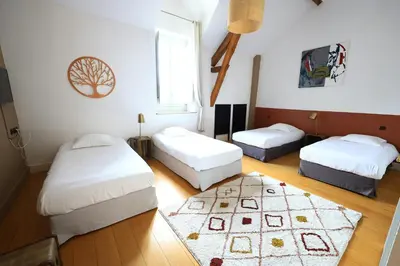 a bedroom with two beds and a rug at Old Hotel Reborn As An Elegant Getaway With Pool in Garrevaques