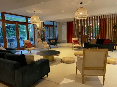 a living room with couches and tables and chairs at Old Hotel Reborn As An Elegant Getaway With Pool in Garrevaques