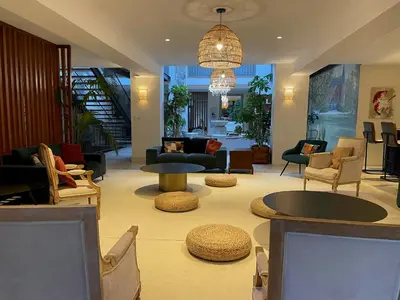 a lobby with chairs and a table and a living room at Old Hotel Reborn As An Elegant Getaway With Pool in Garrevaques