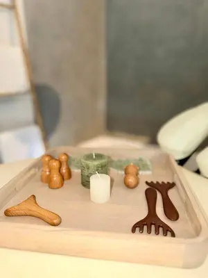 a wooden tray with candles and figurines on a table at Farmhouse With Cathedral Lounge And Sauna In Pines in Cases-de-Pène