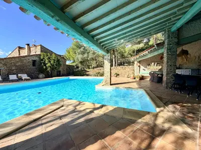an outdoor swimming pool in a villa with a house at Farmhouse With Cathedral Lounge And Sauna In Pines in Cases-de-Pène