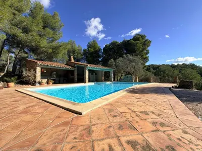 a swimming pool in a yard with a house at Farmhouse With Cathedral Lounge And Sauna In Pines in Cases-de-Pène