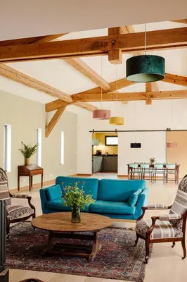 a living room with a blue couch and a table at Accessible Villa In The Heart Of Corbières in Marcorignan