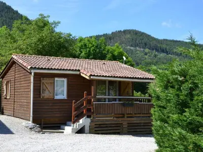 a small cabin with a porch in the mountains at Chalet 4 pers avec terrasse à Roquefeuil - API-1-52-236 in Roquefeuil
