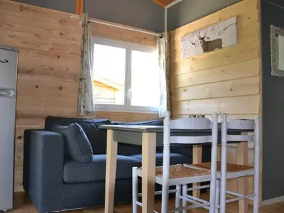 a living room with a couch and a table at Chalet 4 pers avec terrasse à Roquefeuil - API-1-52-236 in Roquefeuil