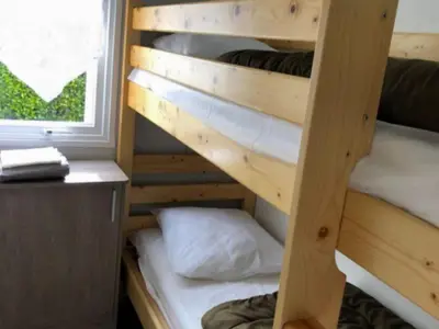 a couple of bunk beds in a room with a window at Mobil home confortable avec 3 chambres et terrasse à Roquefeuil - API-1-52-142 in Roquefeuil