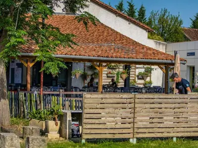 a man standing in front of a house at Mobil-home 2 chambres avec terrasse à Vielmur-sur-Agout - API-1-52-1324 in Vielmur-sur-Agout