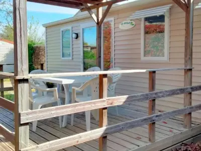 a deck with a table and chairs on a house at Mobil-Home 2 Chambres avec Terrasse - API-1-52-1325 in Vielmur-sur-Agout