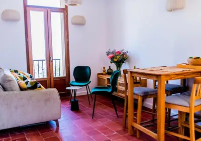 a living room with a wooden table and chairs at Chai Chateau viticole avec piscine dans le sud de la France in Bélesta