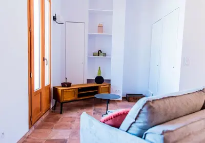 a living room with a couch and a table at Chai Chateau viticole avec piscine dans le sud de la France in Bélesta