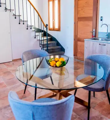 a glass table with a bowl of fruit on it at Chai Chateau viticole avec piscine dans le sud de la France in Bélesta