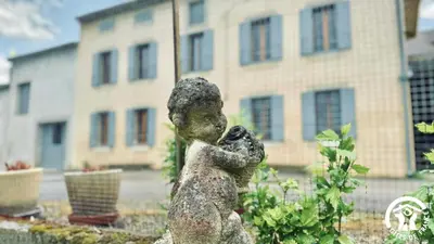 a statue of a bear hugging a dog at Laguzou in Saint-Julien-de-Briola