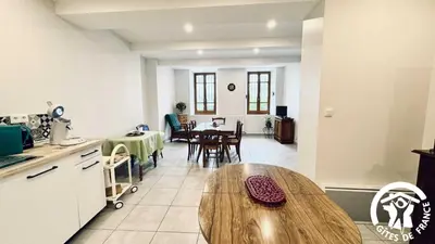 a kitchen and dining room with a wooden table at Laguzou in Saint-Julien-de-Briola