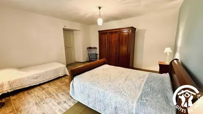 a bedroom with two beds and a closet at Laguzou in Saint-Julien-de-Briola