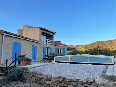 a villa with a swimming pool and a house at Maison idéalement située au milieu des vignes in Planèzes