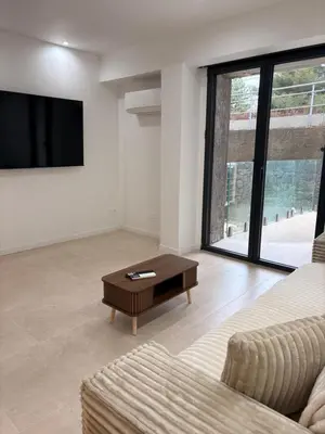 a living room with a couch and a coffee table at Charmant T2 au cœur de ville in Narbonne