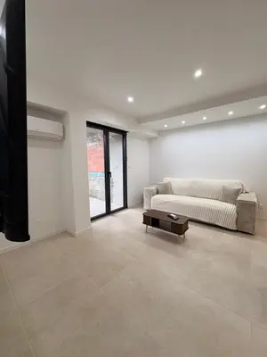 a living room with a couch and a coffee table at Charmant T2 au cœur de ville in Narbonne