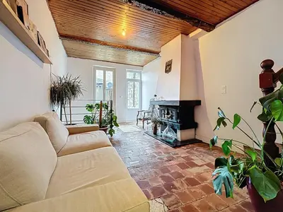 a living room with a couch and a fireplace at Le Triplex - Spacieux appartement proche de la mer in Sigean