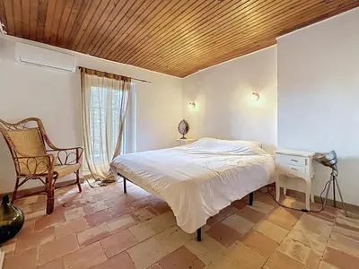 a bedroom with a bed with a wooden ceiling at Le Triplex - Spacieux appartement proche de la mer in Sigean