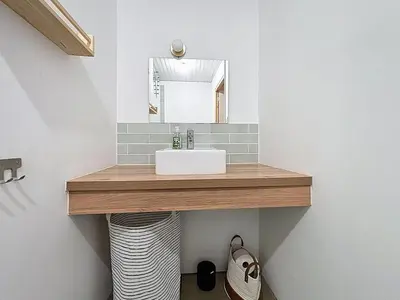 a bathroom with a sink and a mirror at Le Triplex - Spacieux appartement proche de la mer in Sigean