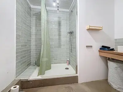 a shower with a glass door in a bathroom at Le Triplex - Spacieux appartement proche de la mer in Sigean