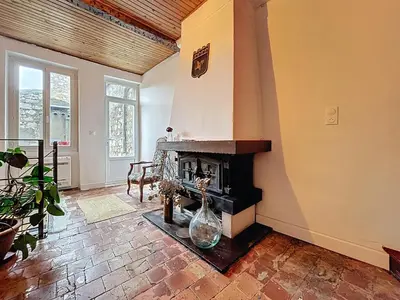 a living room with a fireplace in a house at Le Triplex - Spacieux appartement proche de la mer in Sigean