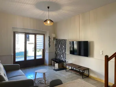a living room with a couch and a tv at Maison village Aude Pays Cathare in Granès