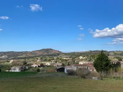 a small town in a field with mountains in the background at Maison village Aude Pays Cathare in Granès