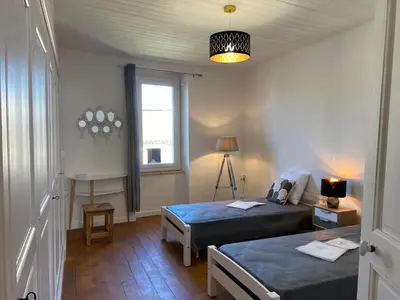 a bedroom with two beds and a window at Maison village Aude Pays Cathare in Granès