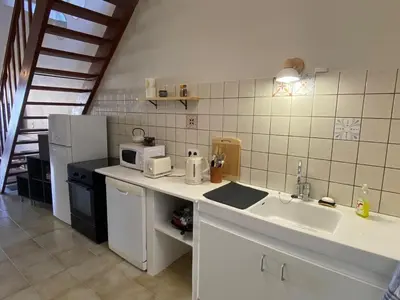 a kitchen with a sink and a microwave at Maison village Aude Pays Cathare in Granès