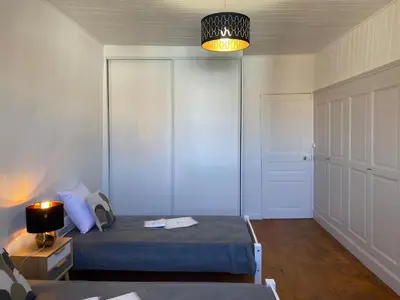 a bedroom with a bed and a lamp and a door at Maison village Aude Pays Cathare in Granès